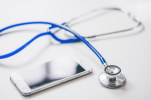 blue stethoscope and smartphone